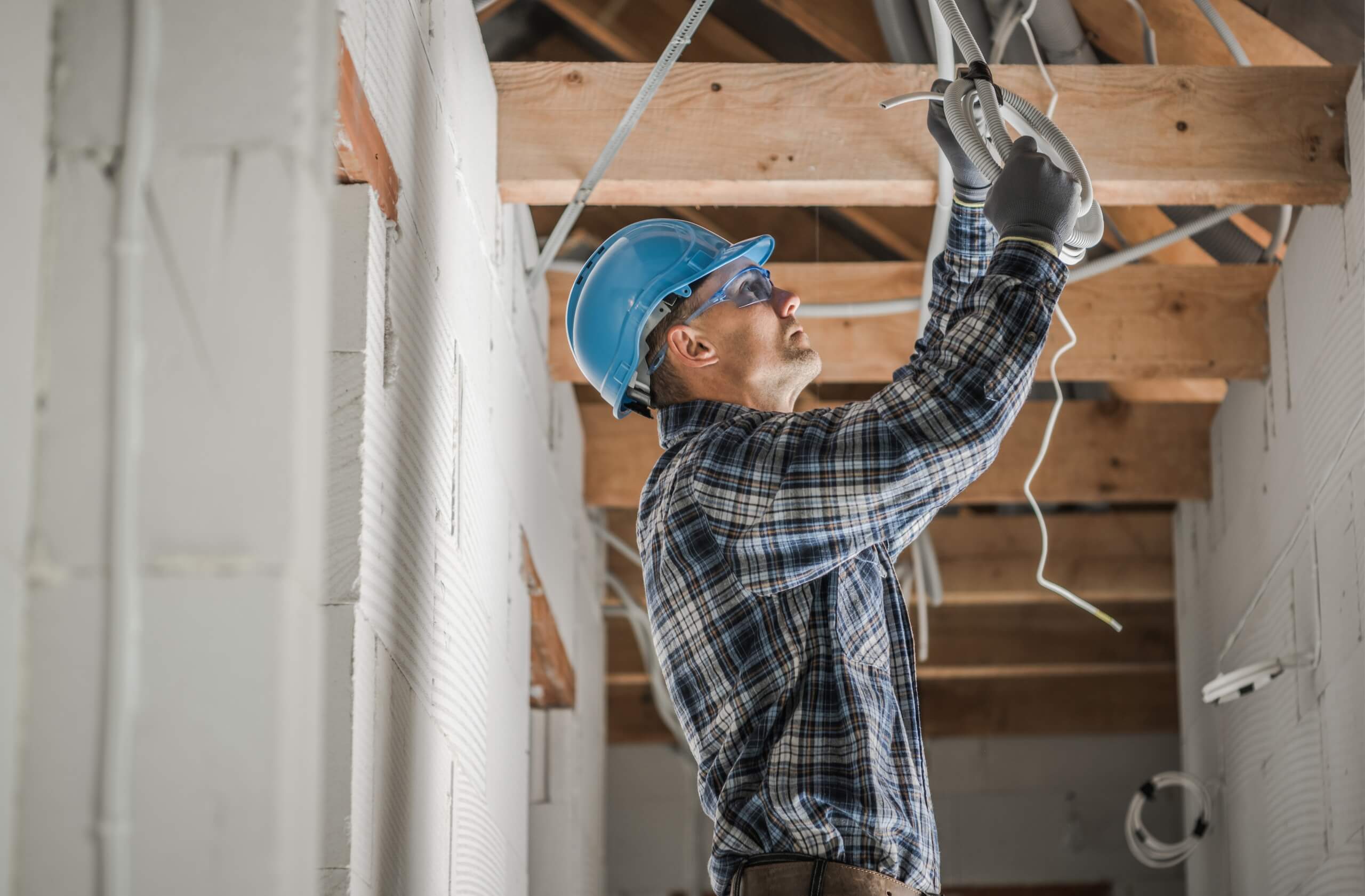 Professional electrician installing a ceiling point